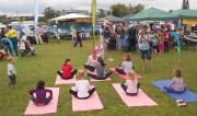 Green Day Out 2011 kids practing yoga at the markets near the river.