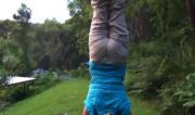 Martine Ford of Spirit Yoga practicing a handstand on a hill