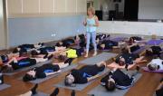 image of Martine Ford of Spirit Yoga walking amidst yoga students