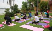 Ladies practicing yoga on the banks of the river for the 'Me Time' Event