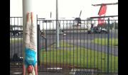 Martine Ford of Spirit Yoga practicing a handstand at the airport