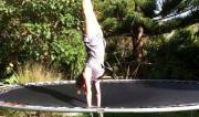 Martine Ford of Spirit Yoga practicing a handstand on a trampoline