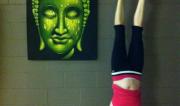 Martine Ford of Spirit Yoga practicing a handstand in the studio