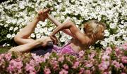 Martine Ford of Spirit Yoga in Gherandasana Pose amongst flowers