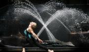 Martine Ford of Spirit Yoga in front of a fountain in a lunge