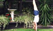 Martine Ford of Spirit Yoga practicing a handstand next to another birdbath