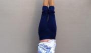 Martine Ford of Spirit Yoga practicing a handstand under a clothes line