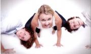Martine Ford of Spirit Yoga in Bakasana with her boys, Trent and Oscar