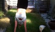 Martine Ford of Spirit Yoga & her rabbit practicing a handstand 