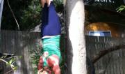Martine Ford of Spirit Yoga practicing a handstand next to a tree